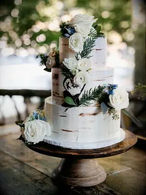 Three-tier rustic wedding cake with birch tree design and fresh flowers