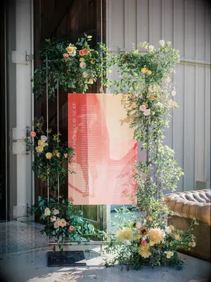 modern wedding seating chart made from marbled acrylic sign with flowers and greenery accents