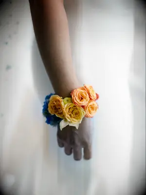 wedding corsage with yellow, orange, red and blue flowers