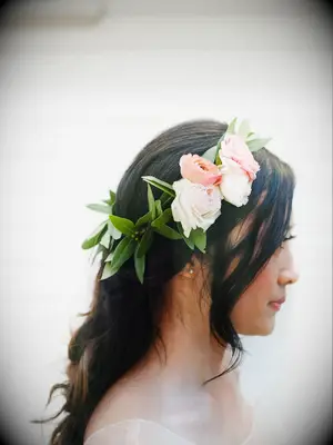 portrait of bride wearing flower crown with pink roses, ranunculus and eucalyptus