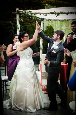 Wedding photo of couple giving each other a high five