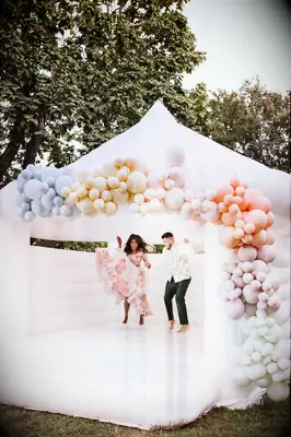 Wedding couple in a bouncy castle for their photoshoot