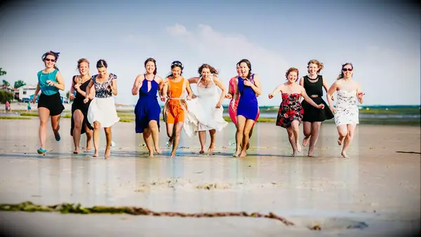 Funny photo of bride running with the wedding party