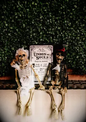Welcome sign with two skeletons dressed as a bride and groom 