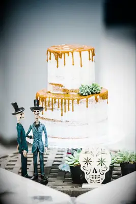 Semi-naked wedding cake with caramel topping at a Halloween wedding