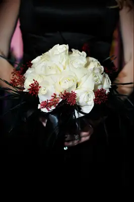 White rose and black feather bouquet at a Halloween wedding