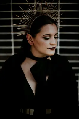 Bride wearing dark makeup and gold headpiece at a Halloween wedding