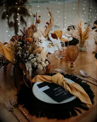 Orange and black tablescape at a Halloween-themed wedding