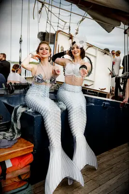 Mermaid entertainers on boat