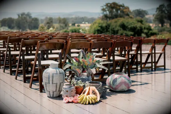 Ceremony aisle decor with woven baskets and fresh fruit