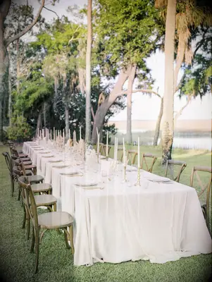Neutral waterfront tablescape with wood cross-back chairs