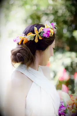 Bride wearing flower crown with orchids