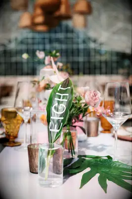 Tropical leaf table number as part of boho tablescape