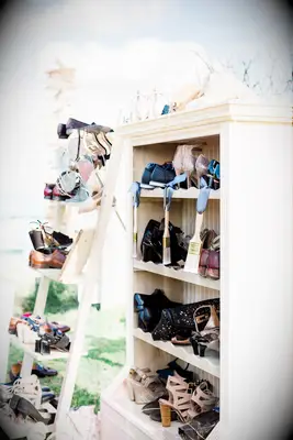 Shelves for shoe check at beach wedding
