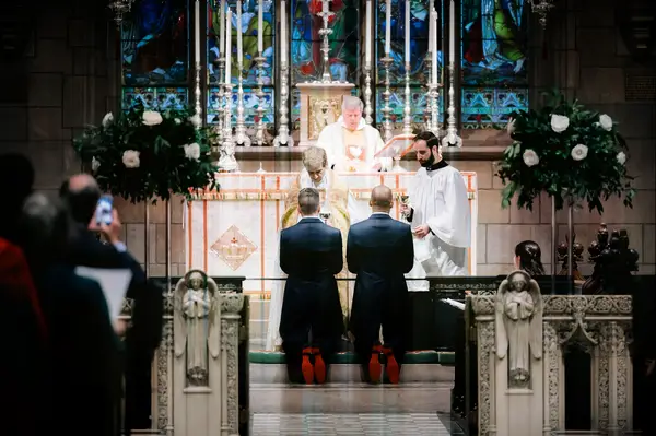 Elevated Flower Arrangements in cathedral wedding ceremony