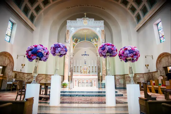 Modern, Jewel-Tone Floral Arrangements on White Pedestals at Saint Anthony Church