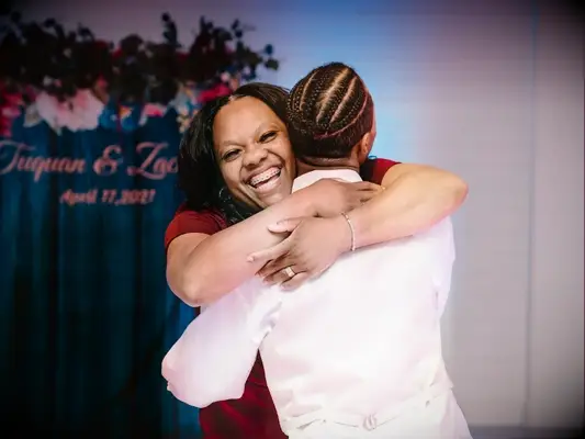 mother and son sharing hug during mother-son wedding dance