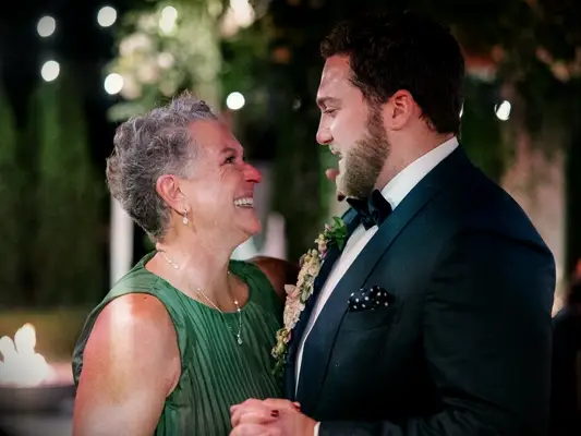 mother and son dancing during reception 
