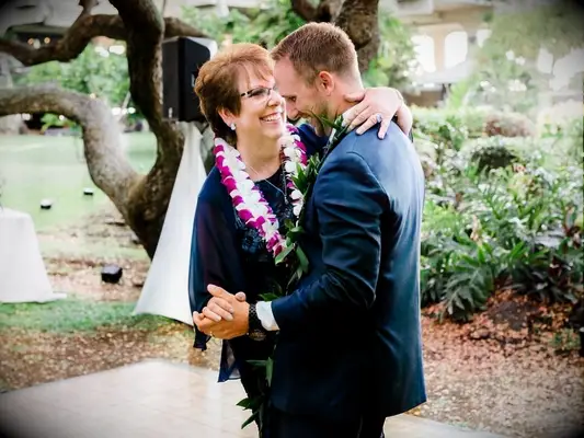 mother of the groom dancing with groom at wedding