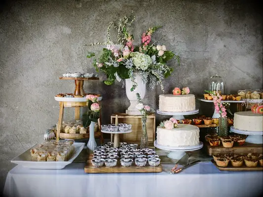wedding dessert spread decorated with flower arrengement