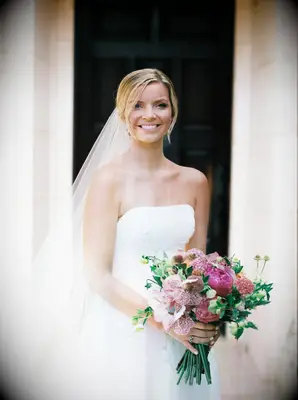 Bride in Veil and Strapless Wedding Dress Holding Jewel Tone Flower Bouquet