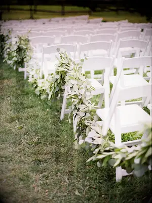 outdoor wedding ceremony aisle with eucalyptus garland