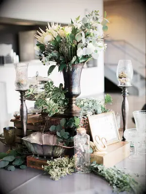 wedding centerpiece with greenery and bronze vessels