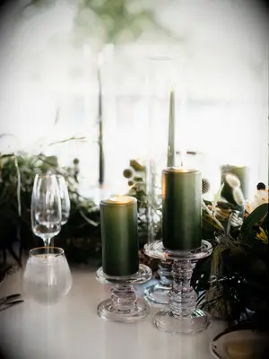 wedding tablescape with olive green pillar candles and taper candles