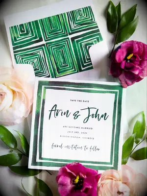 watercolor wedding invitation with emerald green border and geometric envelope liner