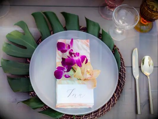 wedding place setting with monstera leaf under charger plate