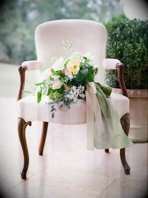 garden wedding bouquet with long sage green ribbons around stems
