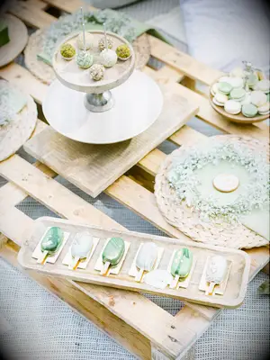 wedding dessert display with sage green popsicles and cake pops