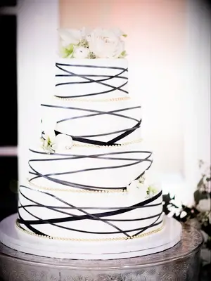 White wedding cake with black abstract lines and gold details