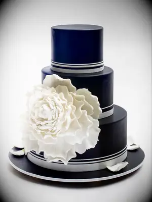 Black wedding cake with large white peony decal. 