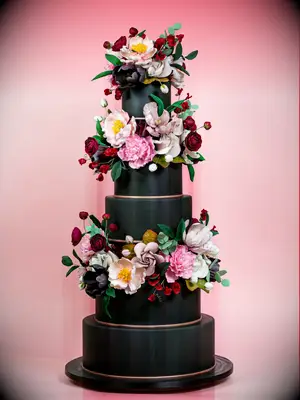 Large black wedding cake with fresh flowers. 