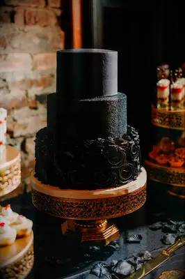 Alternating three-tier black wedding cake. 