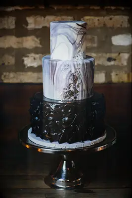Three-tiered black marble wedding cake. 