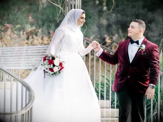 Couple holding hands and walking during wedding portraits
