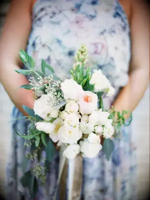 This burgeoning bouquet is simply one of a kind, with pale pastels and delicate greenery.