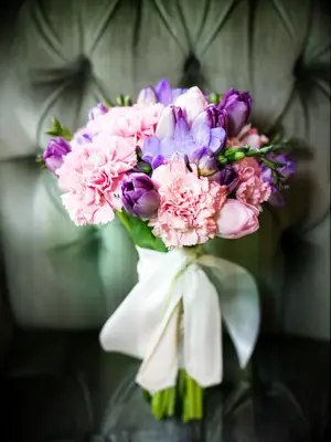 This spring wedding bouquet bursts with pink and purple pastels.