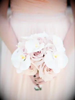 This springtime bouquet showcases gorgeous white orchids and pale pink roses.
