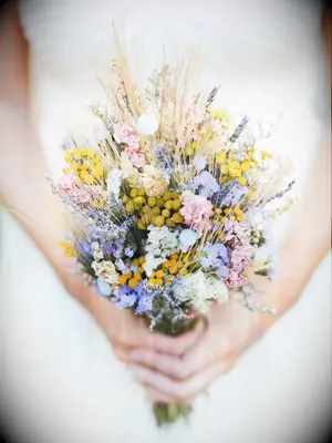 This rustic bouquet, in its pastel shades, showcases dried flowers front and center.