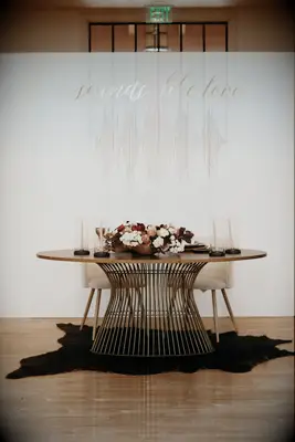 unique wedding sweetheart table idea with custom backdrop featuring a sound wave and the words sounds like love in gold lettering