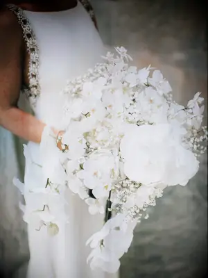 closeup of luxury wedding bouquet with white phalaenopsis orchids in cascading shape