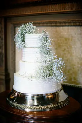 four tier buttercream wedding cake with baby
