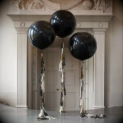 affordable wedding decoration idea oversized round black balloons with gold and white tassel strings