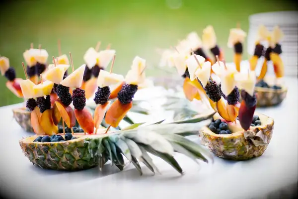 Refreshing fruit skewers in a pineapple boat for your outdoor wedding