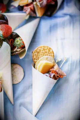 Charcuterie meat, cheese and cracker cones for your wedding food ideas