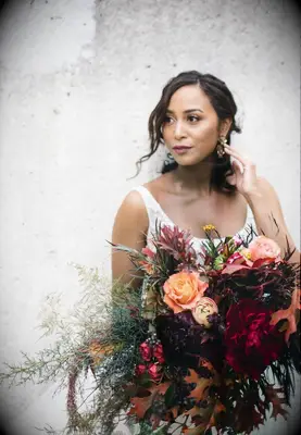 Bride holding large red bouquet