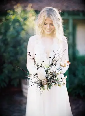 Bride holding bouquet with branches